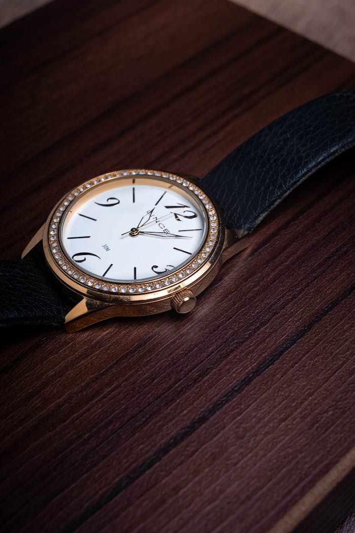 Close-up shot of a luxury analog wristwatch on a wooden tray, perfect for lifestyle themes.